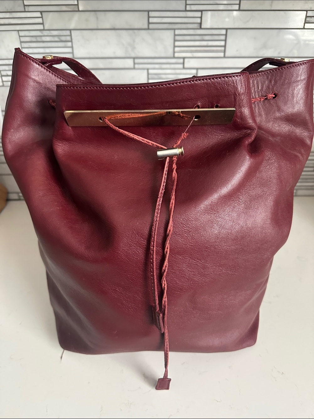 Alberta Di Canio Burgundy Leather Drawstring Shoulder Bag with Gold Bar